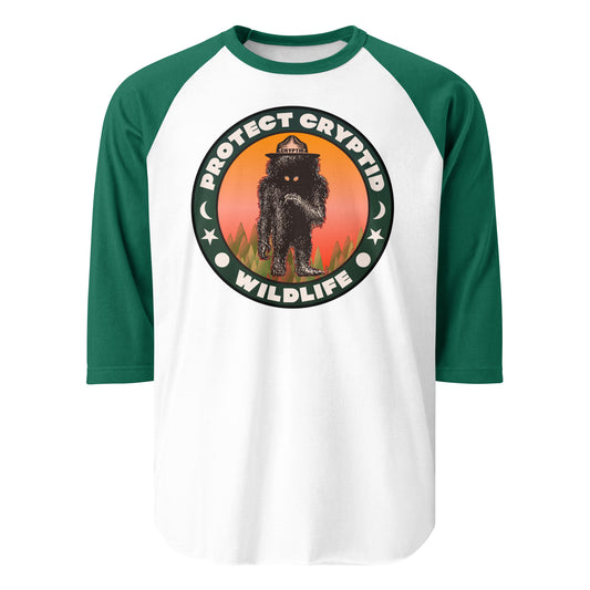 A kelly green and white three quarter sleeve retro shirt that says Protect Cryptid Wildlife about safeguarding undiscovered animals. Image of sun, moon, and stars. Image of mythical black creature with yellow eyes in a green forest with a hat that says cryptid. 