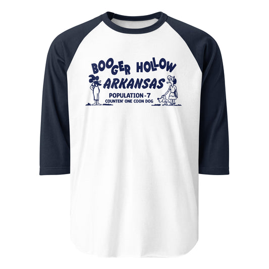 A three quarter sleeve raglan navy and white travel shirt that says Booger Hollow Arkansas and Population - 7 Counten' One Coon Dog. Images of a wild west man smoking a pipe and a woman smoking with a dog. 
