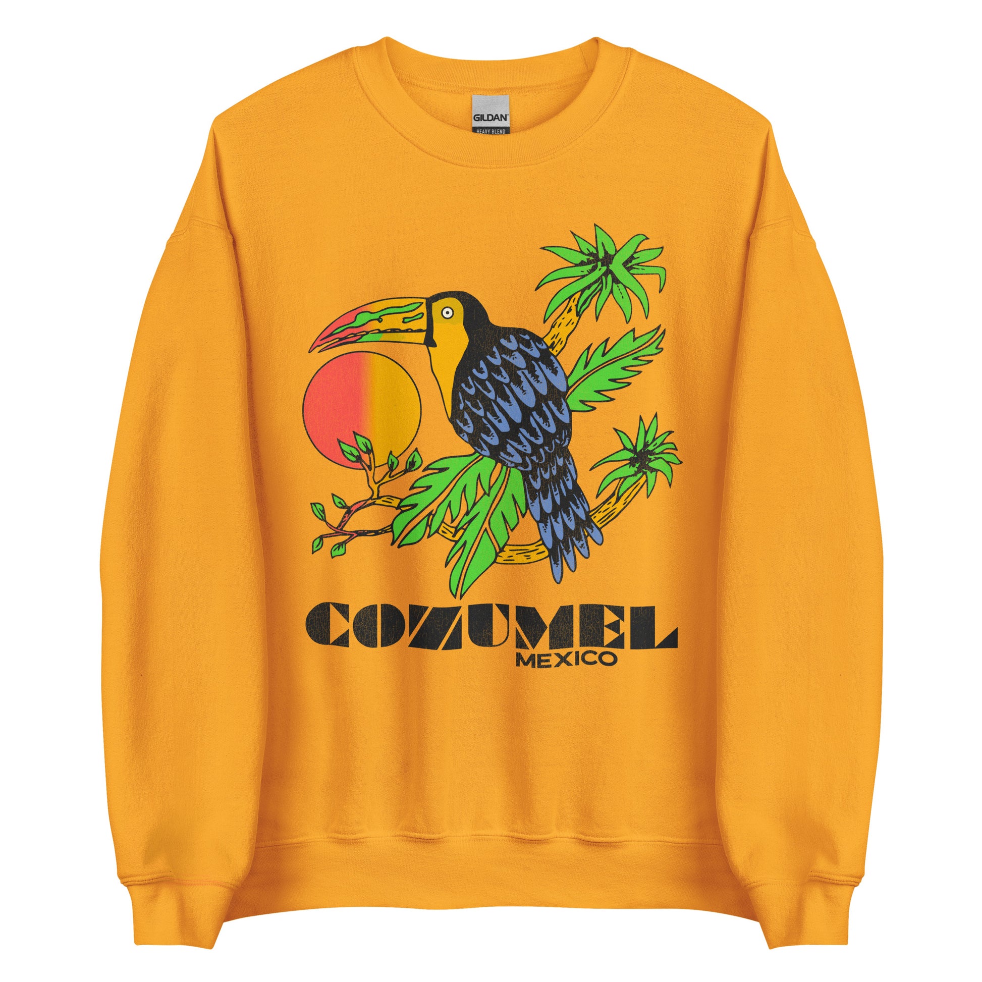 An orange-yellow crew neck travel sweatshirt that says Cozumel Mexico, a tourist destination island in the Caribbean popular for cruise ship visits. Has a blue black tropical bird with a beak that matches the orange red sunrise sitting on tropical palm tree branches. 