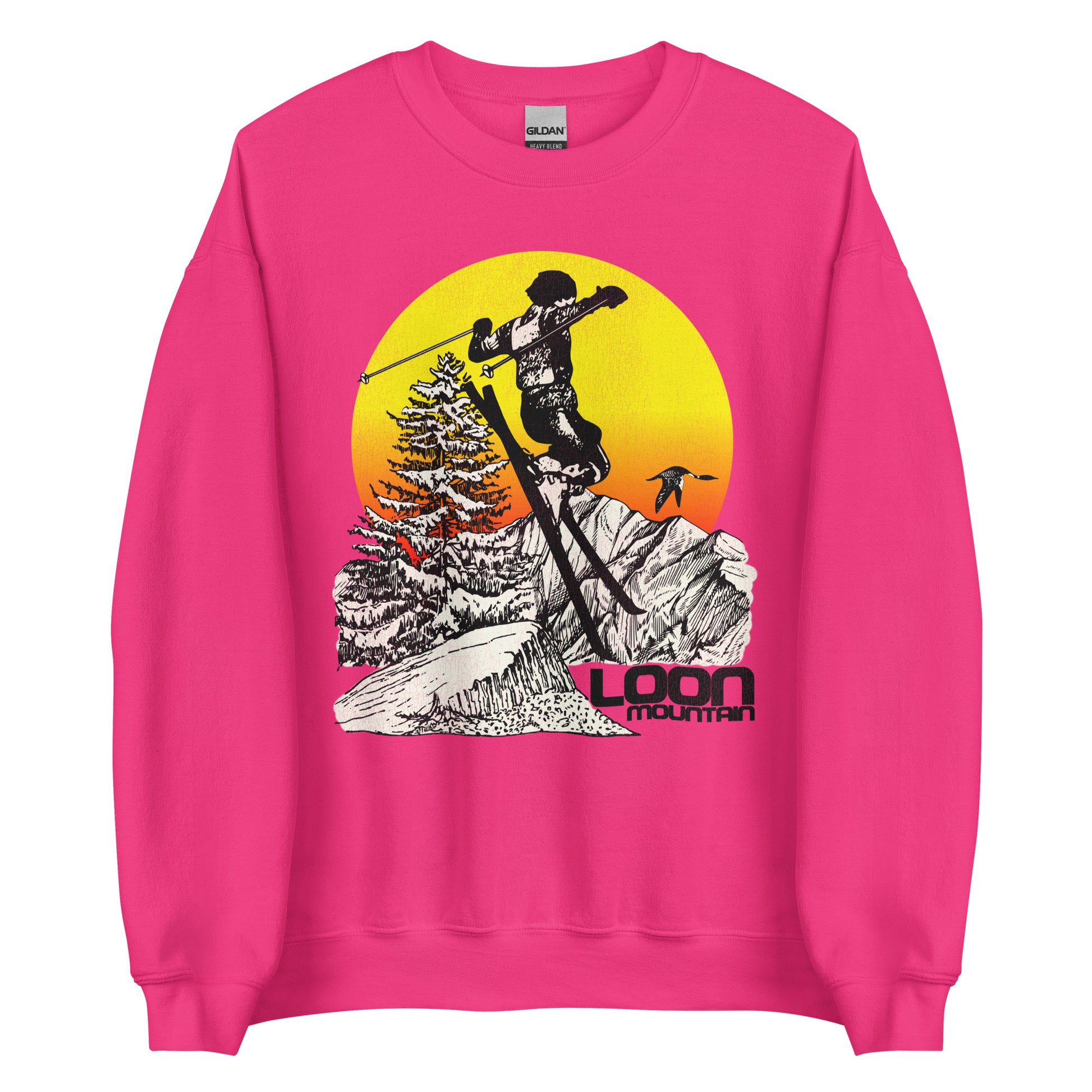 A heliconia colored pink crew neck retro style sweatshirt that says Loon Mountain from Loon Mountain Resort in New England. Image of man skiing by the White Mountains, a loon bird flying, snow colored aspen tree, and a yellow and orange sunrise. 