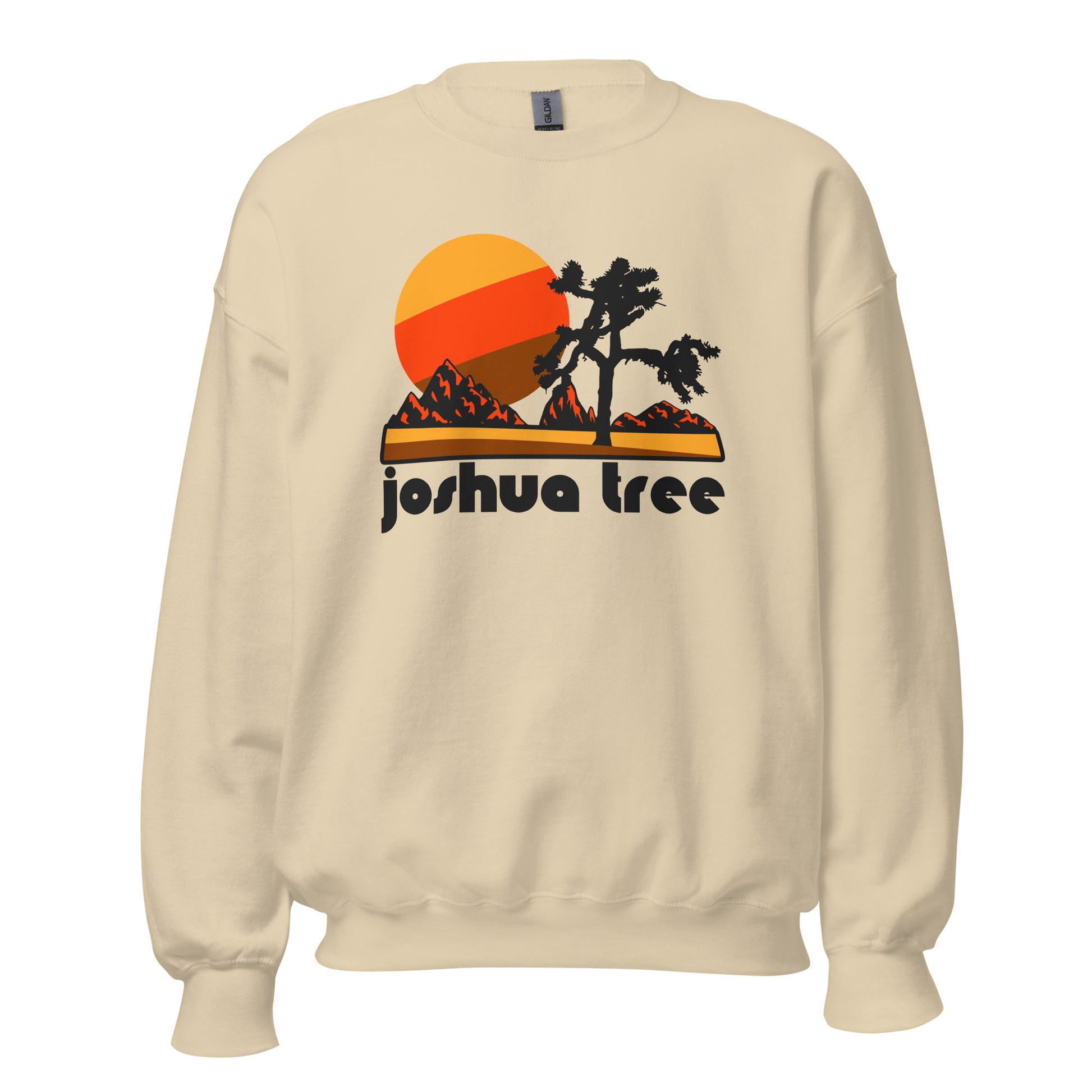A 70s style retro crew cut sand colored sweatshirt with the text Joshua Tree. Includes an image of the California National Park, with a tree resembling a cactus, a red mountain landscape, and a setting sun. 