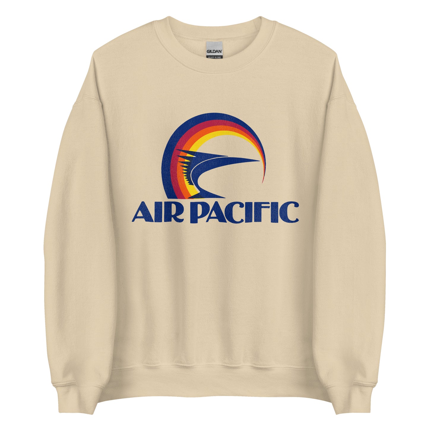 A retro sand colored crew neck sweatshirt with the Air Pacific (now Fiji Airways) logo including circular lines of blue, red, orange, and yellow, and a navy blue fish with spikes. 