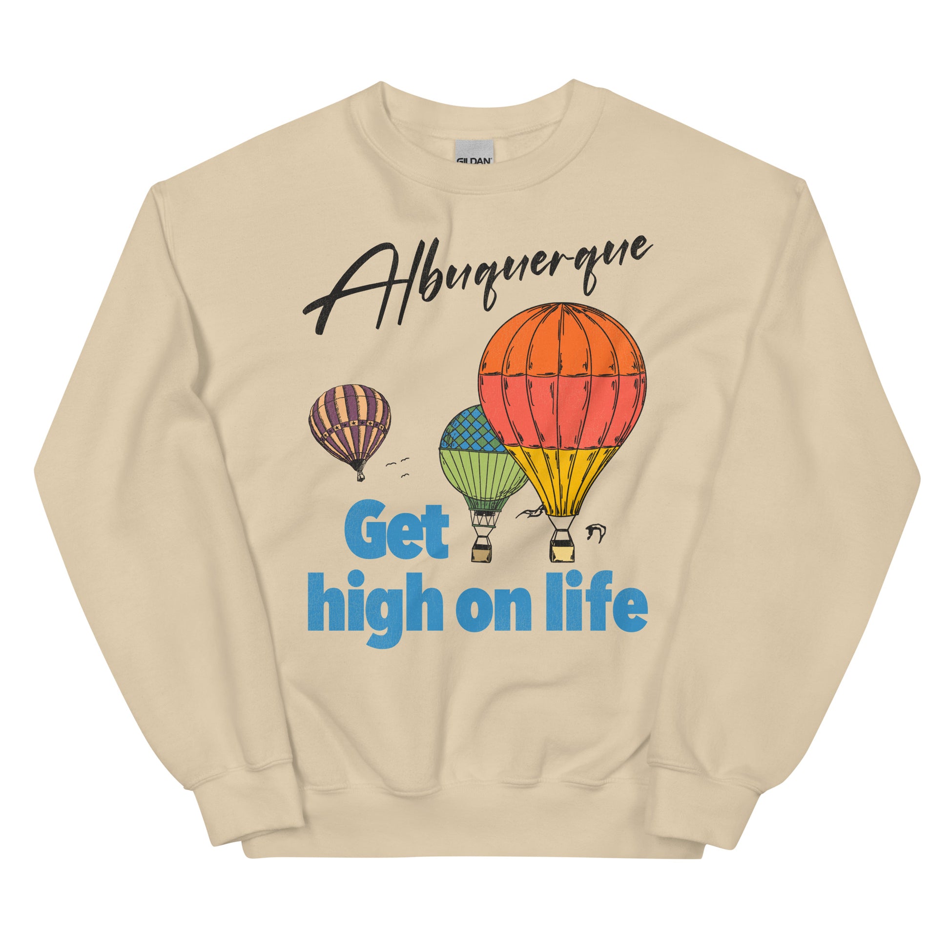 A sand colored vintage crew neck sweatshirt that says Albuquerque, referring to the Albuquerque Balloon Festival. Says "Get high on life" in blue block letters with three aesthetically designed hot air balloons flying in the sky. 