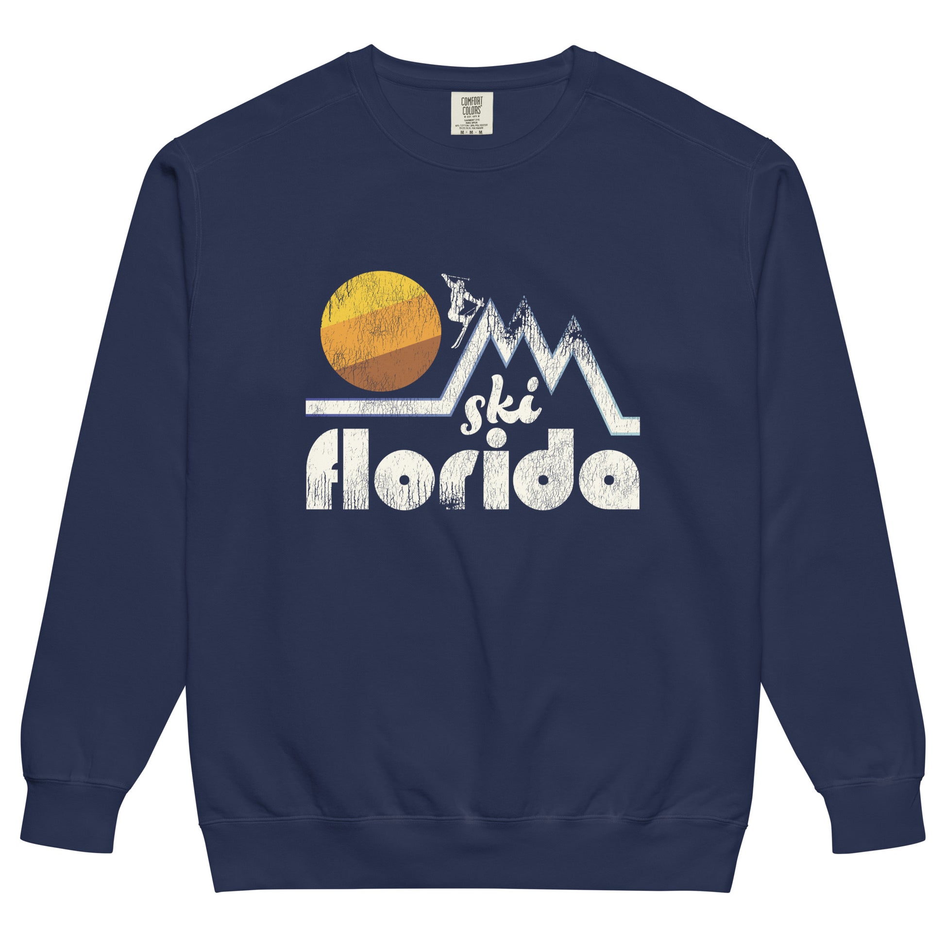 A retro 80s style tourist navy colored crew neck sweatshirt that says "Ski Florida" under the image of a skier on top of a mountain range with a circular sun in the background. 