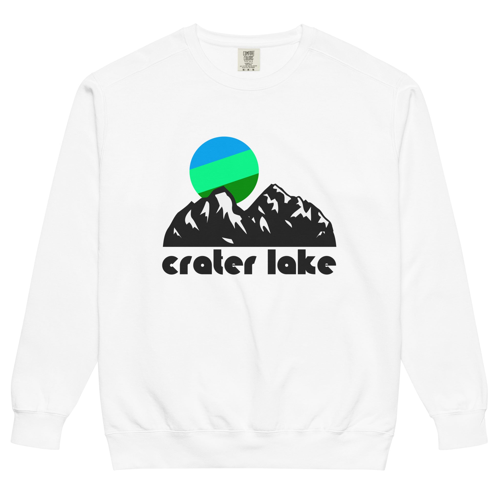 A vintage, 70s style Crater Lake crew neck sweatshirt in the color white. Includes the image of mountains topped by a blue, mint green, and forest green colorful sun, referencing the Cascade Mountain Range and Crater Lake National Park, a pristine location for hiking, backpacking, sightseeing, and touristing, with stunning views of the deepest lake in the entire United States, activities like driving around the lake on Rim Drive or fishing or swimming in the water, and opportunities for photography and art.