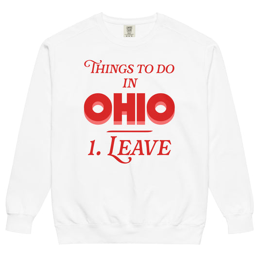 A white colored vintage crew neck Ohio sweatshirt that makes fun of the state, stating "Things to Do in Ohio: 1. Leave", referencing various internet and social media memes that hate on the midwestern state in a joking way. 
