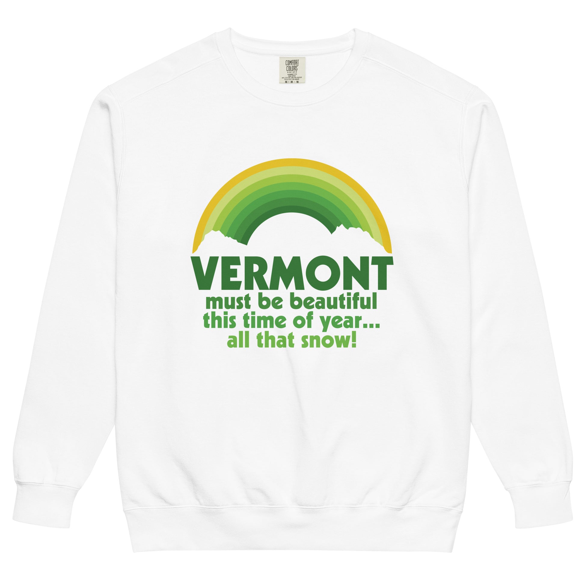 A vintage, 80s style tourist white colored crew neck sweatshirt that says "Vermont must be beautiful this time of year... all that snow!" in various shades of green, referencing the 1954 musical comedy film "White Christmas". Image of a green and gold rainbow above the words, and two white clouds. 
