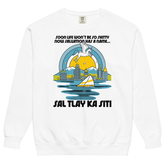 A crew neck white 80s style vintage sweatshirt. Has lyrics from the song Sal Tlay Ka Siti, from the musical The Book of Mormon, "Soon life won't be so shitty now salvation has a name...". Image of a magical blue and white unicorn floating above Salt Lake City, Utah, considered paradise in the song, with a picturesque yellow and white sailboat on the Great Salt Lake and a beautiful yellow sun surrounded by a blue sky. 