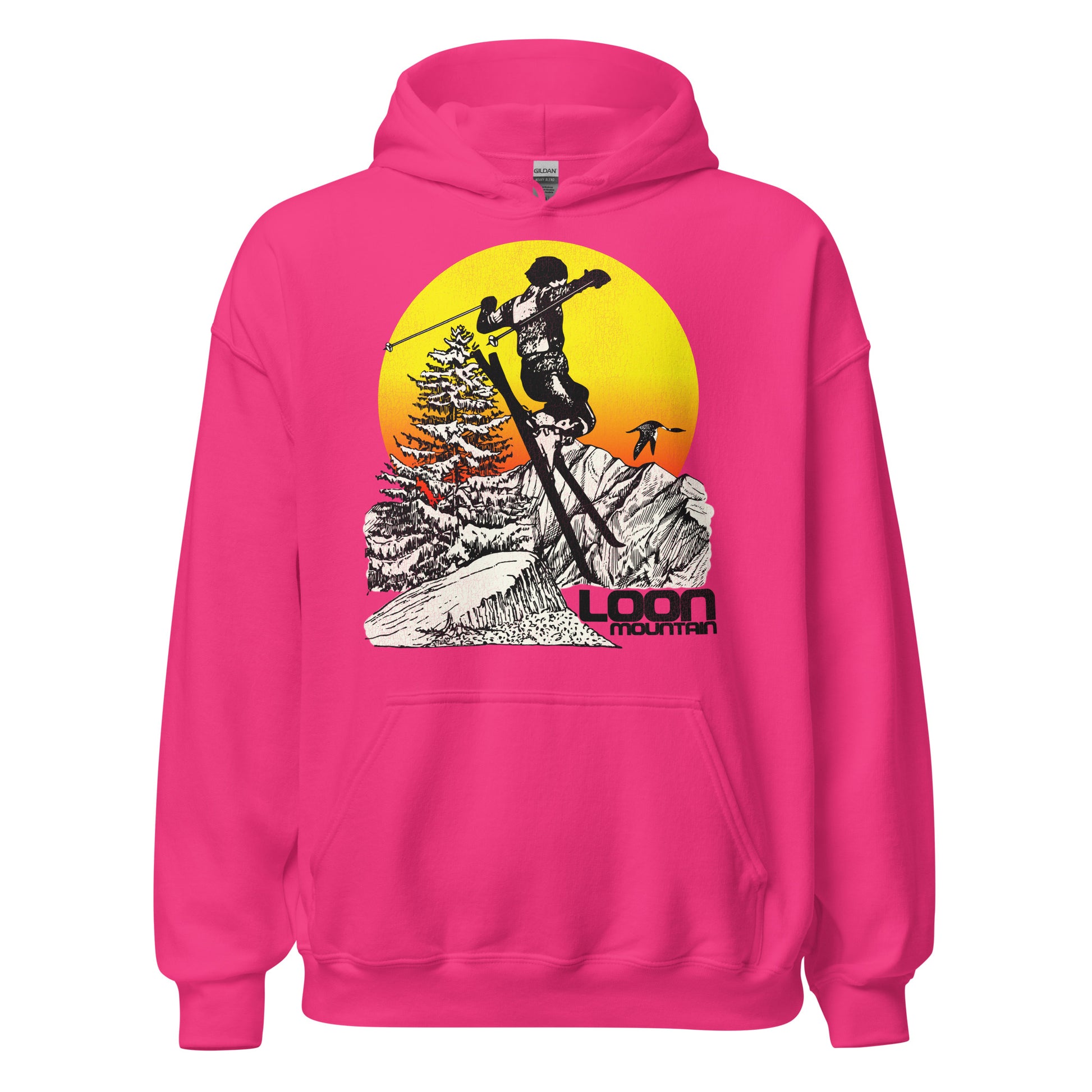 A bright pink heliconia travel hoodie sweatshirt with the text "Loon Mountain", the ski and snowboard resort in the White Mountain Range in New England. Image of skiier flying past beautiful snow covered mountains, a loon bird, a tree, and a bright yellow and orange sunset. 