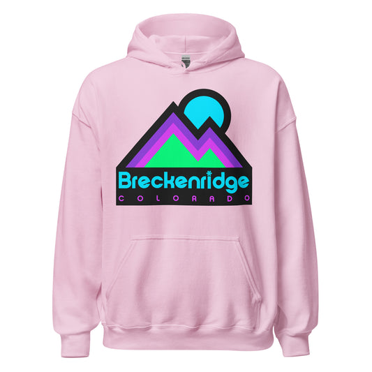 A light pink vintage hoodie sweatshirt that says Breckenridge, Colorado in neon blue and purple colors, with the image of two mountain peaks and a sun in mint green, magenta, and purple. References the popular tourist destination Coloradan town, known for its skiing, snowboarding, and hiking opportunities, as well as its charming art scene, stunning mountain views, and rich history of mining. 