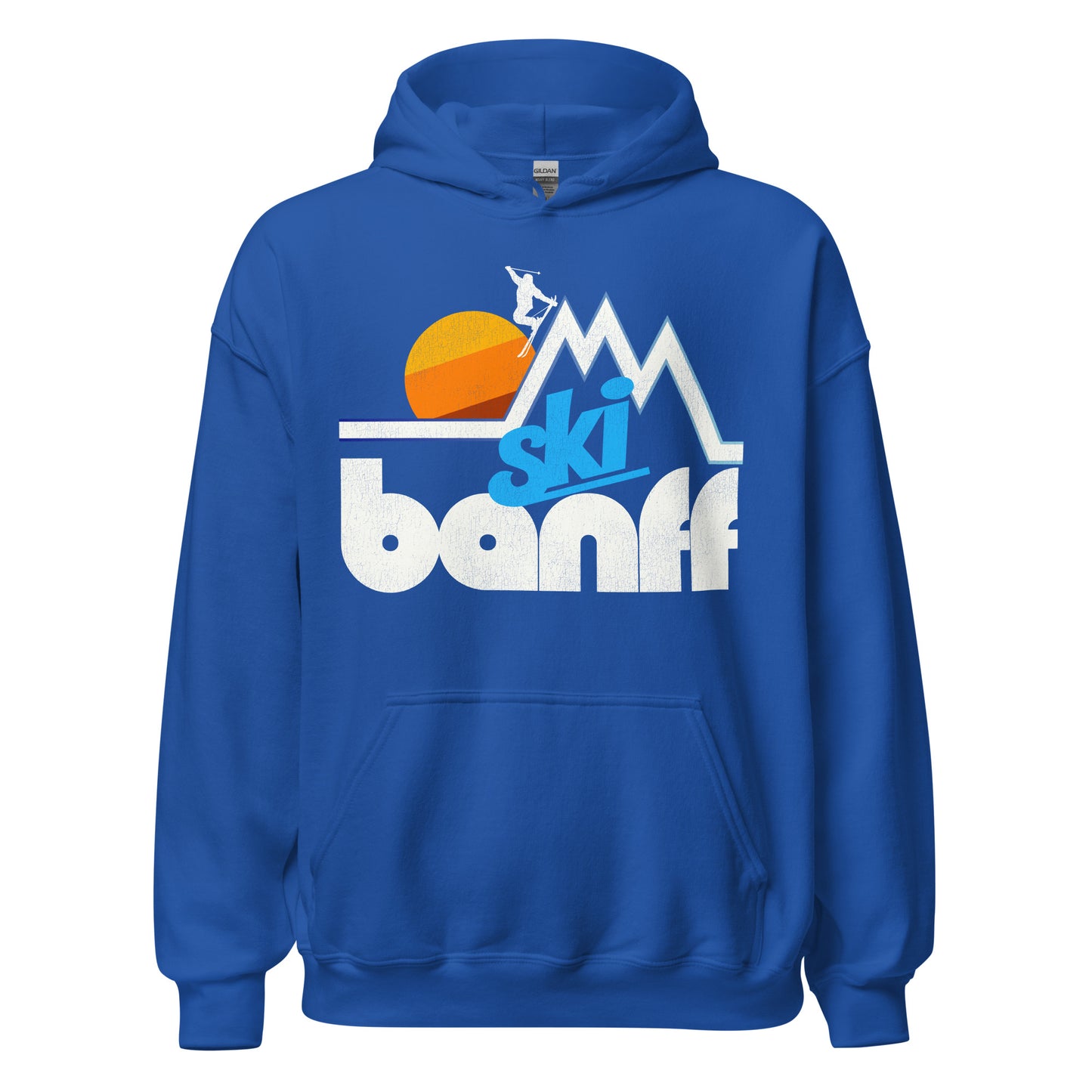 A souvenir retro Ski Banff royal blue hooded sweatshirt. Image of a skier jumping off of a mountain peak in a stylized way in front of a rising tricolored sun. References the national park in the Alberta Rocky Mountains, known as Canada's first national park and a UNESCO World Heritage Site. 