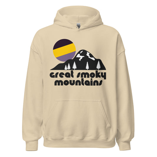 A vintage souvenir hooded sweatshirt in a sand color that reads 'great smoky mountains' underneath the image of a large mountain, its base dotted with pine trees, a tricolored bright purple and yellow sun rising above its peak. In reference to Great Smoky Mountains National Park, a popular destination for hiking, backpacking, and skiing, multiple mountain ranges like the Appalachians and Blue Ridge Mountains.  
