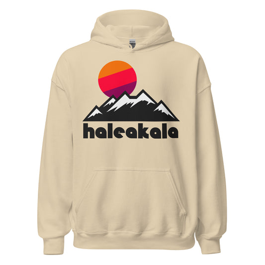 A retro, souvenir Haleakala sand colored sweatshirt which includes an artistic mountain landscape with snow on the tops, an orange, pink, and purple sun setting from just above the peaks. It references Haleakalā National Park, located in Maui, Hawaii, known for its namesake, an active volcano, and the majestic night sky views from the summit. 