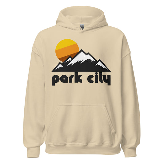 A vintage, souvenir Park City Mountain Resort sand colored hooded sweatshirt that includes the image of a mountain range topped in snow under a rising yellow, orange, and red sun, representative of the Wasatch Mountains in Utah, popular for all kinds of tourists and adventurers including hikers, mountaineers, skiers, and snowboarders. 