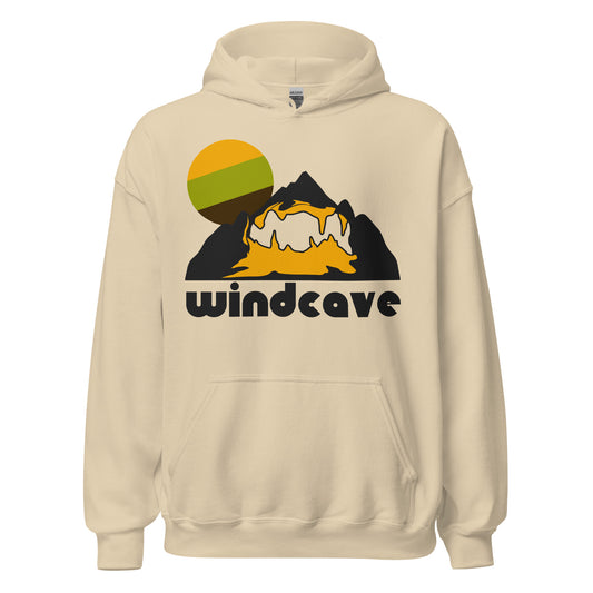 A sand colored 70s style retro Wind Cave hooded sweatshirt with the image of a cave system within an enormous mountain and a setting sun, representing Wind Cave National Park's incredible cave hiking opportunities for tourists and cave aficionados. The national park is known as one of the largest cave systems in the world, and also has stunning prairie and pine forest landscapes, close to the Black Hills of South Dakota. 