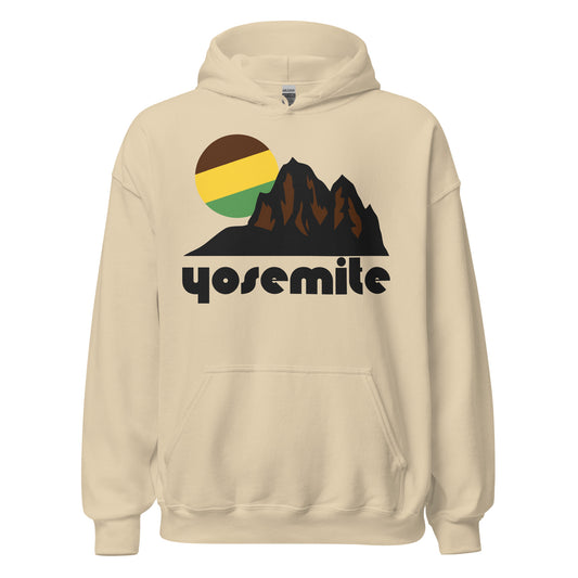 A sand colored retro 70s style hooded sweatshirt with the name Yosemite on it, referencing the Californian national park in the Sierra Nevada Mountain Range. Image of brown mountains, cliffs, and peaks and a circular green/yellow/brown colored sun peaking out behind the mountain landscape. 