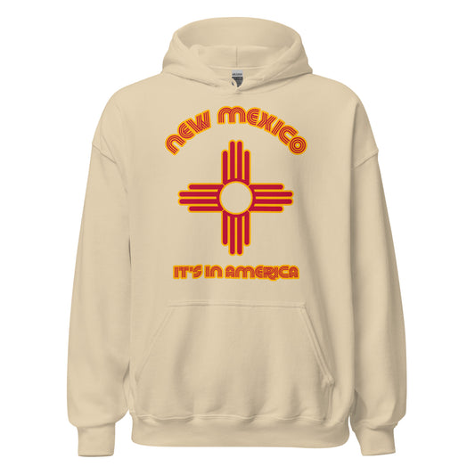A retro, souvenir New Mexico sand colored hoodie sweatshirt that says 'It's in America' with an image of the Zia cross design found on the New Mexico state flag which comes from the Zia Tribe and represents the four stages of life, the four cardinal directions, and the sun. 