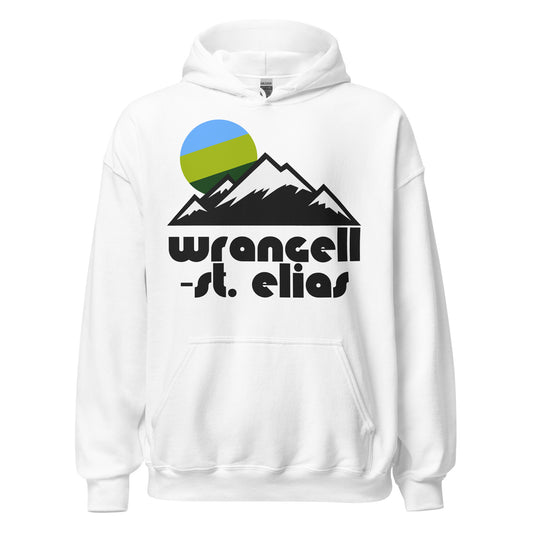A retro travel white colored hooded sweatshirt for tourists that says Wrangell-St. Elias, the national park and preserve in Alaska known as the largest in the United States. The sweatshirt has the image of a mountainous landscape with snowy peaks and a rising blue and green colored sun. 