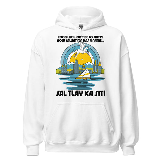 A vintage 70s style white Sal Tlay Ka Siti hoodie sweatshirt that says "Soon Life Won't Be So Shitty Now Salvation Has A Name...". A unicorn flies across a sunny blue ringed sky with tiny, picturesque clouds, over the snowcapped mountains and buildings of Salt Lake City and the blue waters of the Great Salt Lake, with sailboats. References the Broadway hit musical The Book of Mormon, and the song Nabulungi sings about paradise in Utah. 