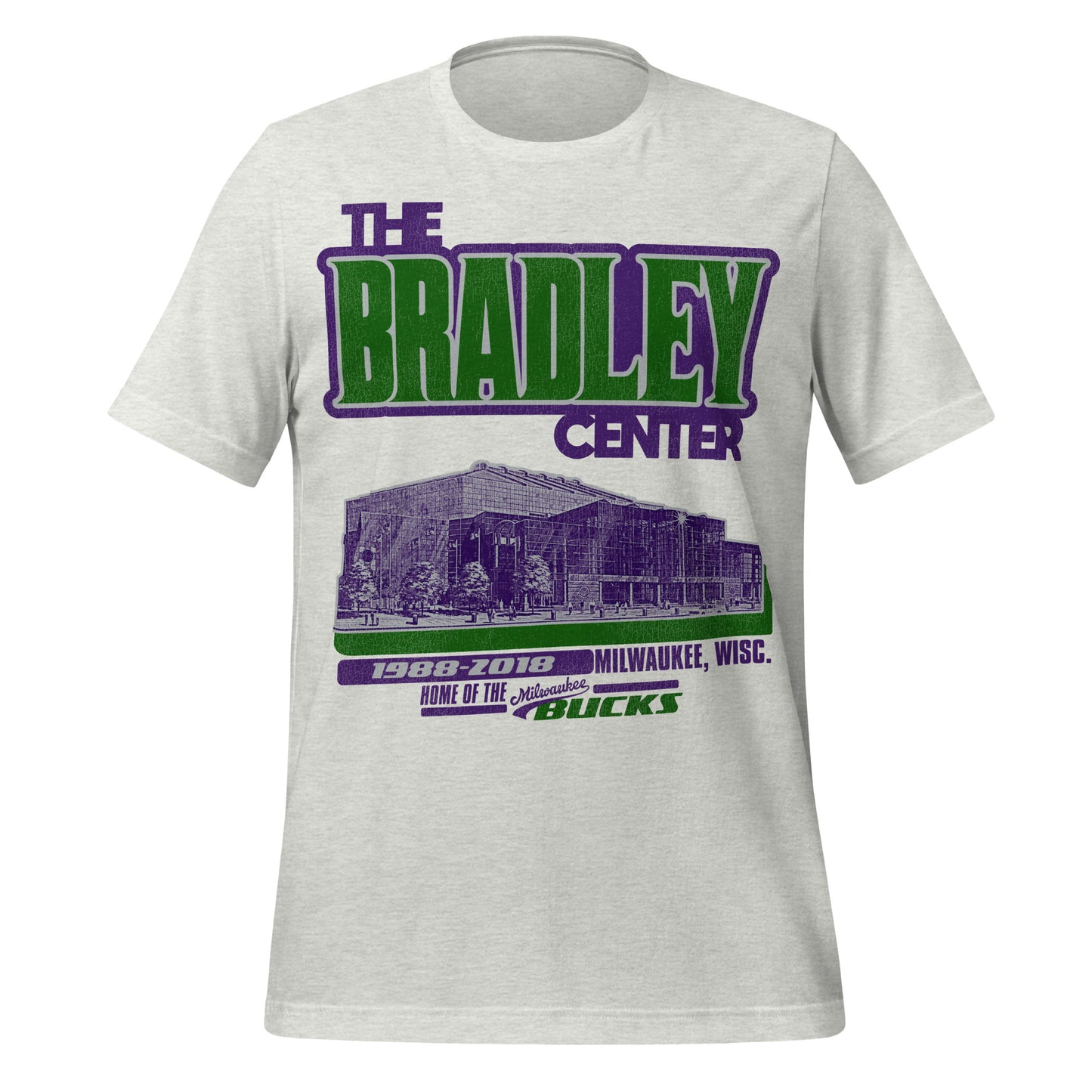 A 70s style ash gray t-shirt reading "The Bradley Center" in the colors of the Bucks NBA team, green and purple. Says "Home of the Milwaukee Bucks" who played in the stadium from "1988-2018" in "Milwaukee, Wisc." Image of the outside of the stadium from the street in purple. 