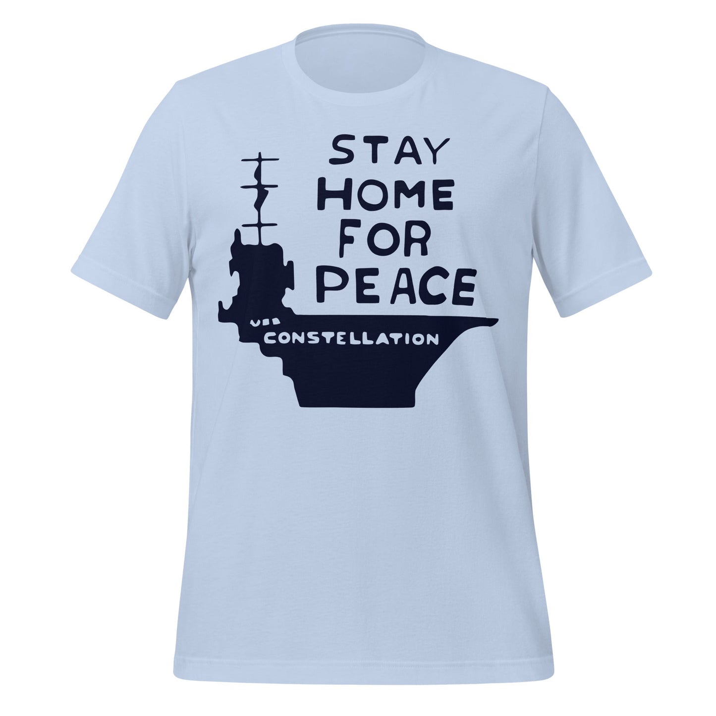 A baby blue vintage t-shirt that says "Stay Home for Peace" and a large image of a ship with the name "USS Constellation". References peace activist Connie Picciotto who protested in a vigil by the White House during the Vietnam War. 