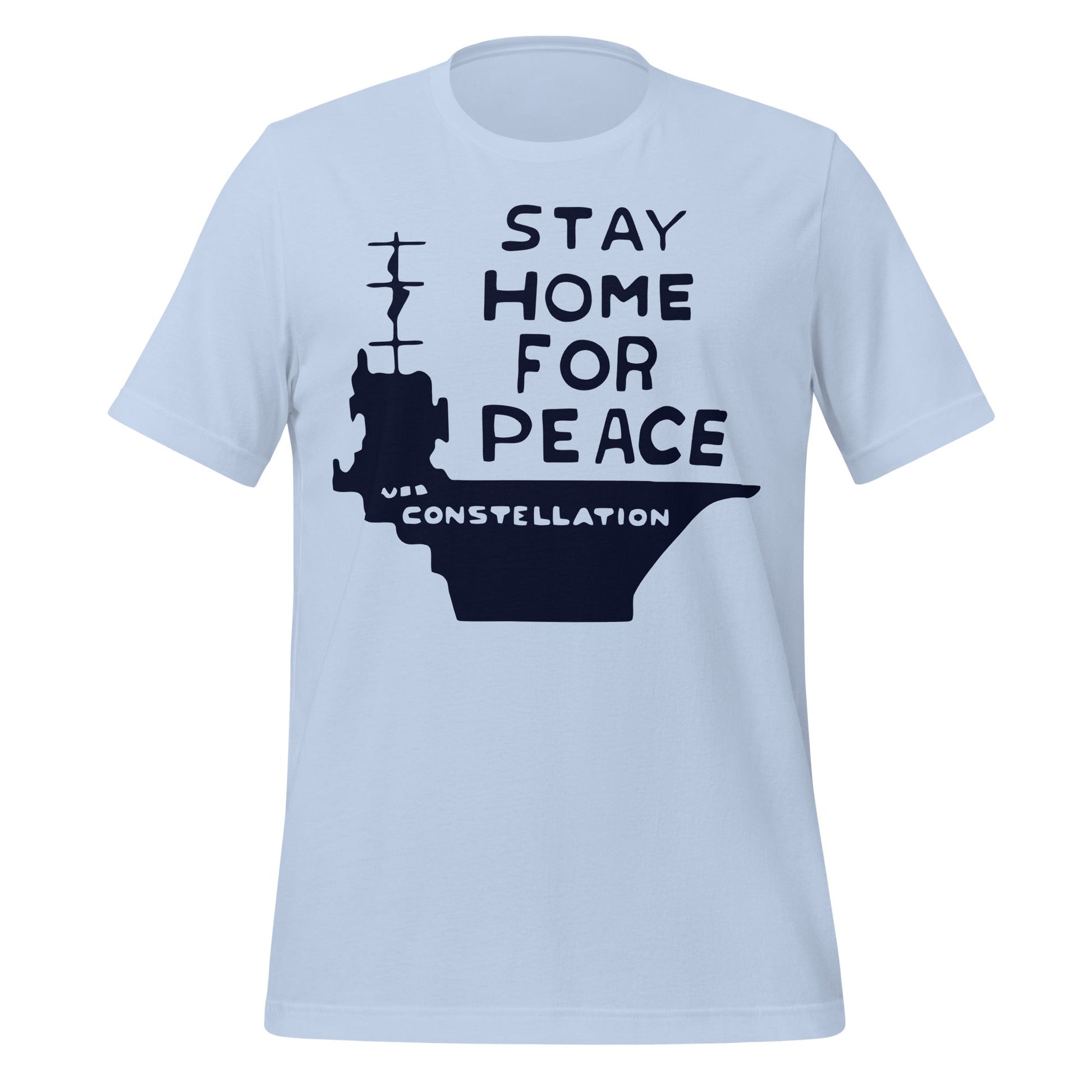 A baby blue vintage t-shirt that says "Stay Home for Peace" and a large image of a ship with the name "USS Constellation". References peace activist Connie Picciotto who protested in a vigil by the White House during the Vietnam War. 