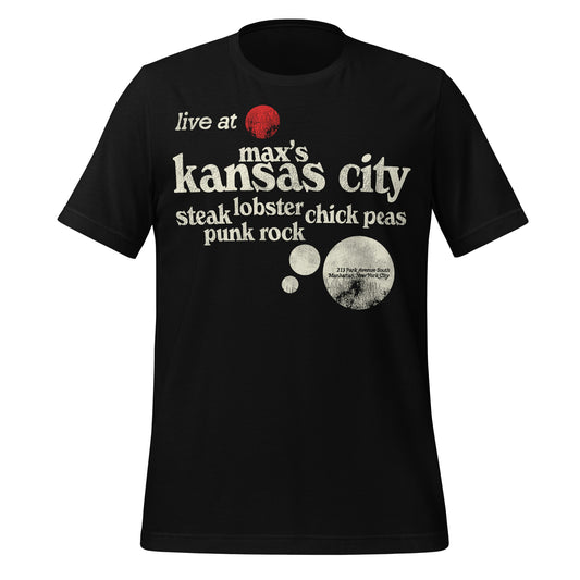 A black vintage "Max's Kansas City", a legendary NYC nightclub, t-shirt that says "Live at Max's Kansas City" and "Steak, Lobster, Chick Peas, Punk Rock". Includes the address "213 Park Avenue South, Manhattan, New York City." Image of a red circle with black lines, their logo which referenced the Dan Flavin red fluorescent sculpture in their backroom which was nicknamed "Bucket of Blood. 