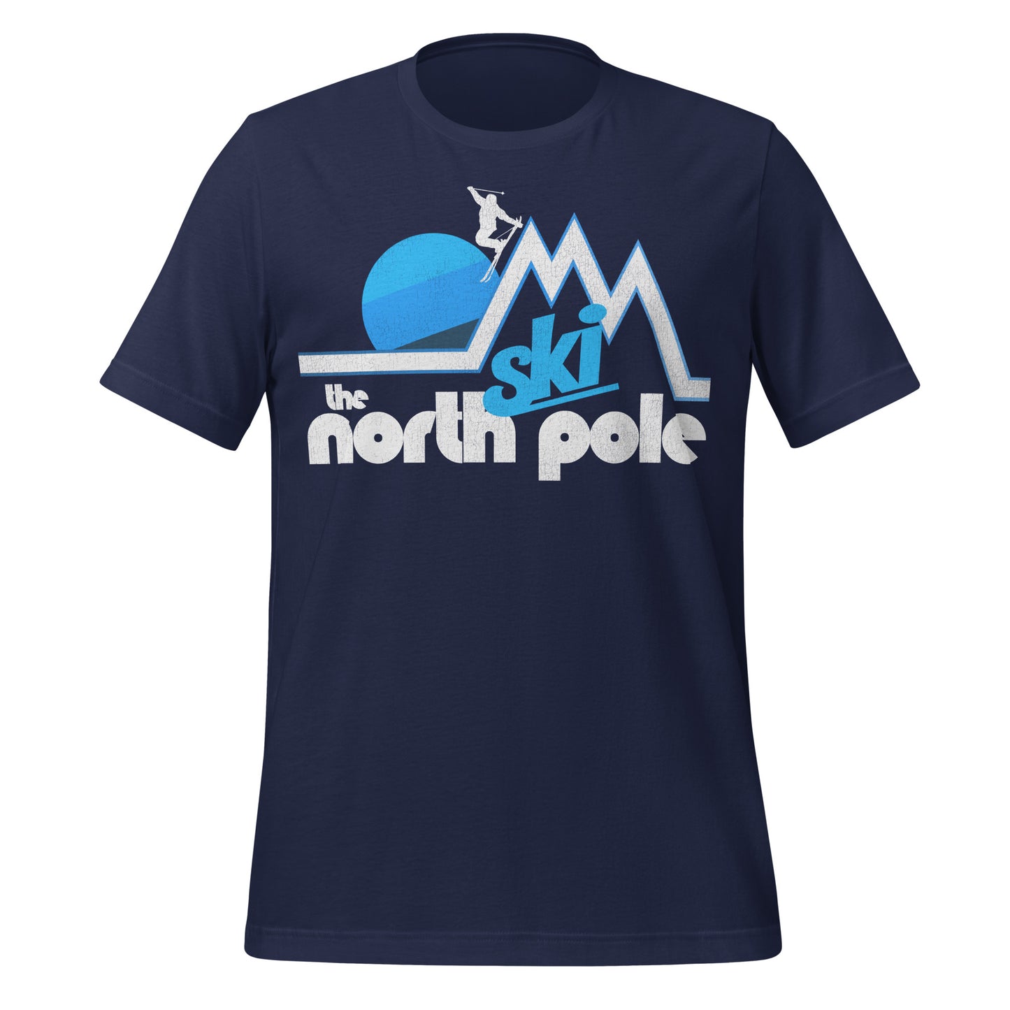 A vintage souvenir navy blue t-shirt with the words "Ski the North Pole" underneath an image of white and blue mountain peaks with a skier jumping off aesthetically as a blue striped sun sets behind. 