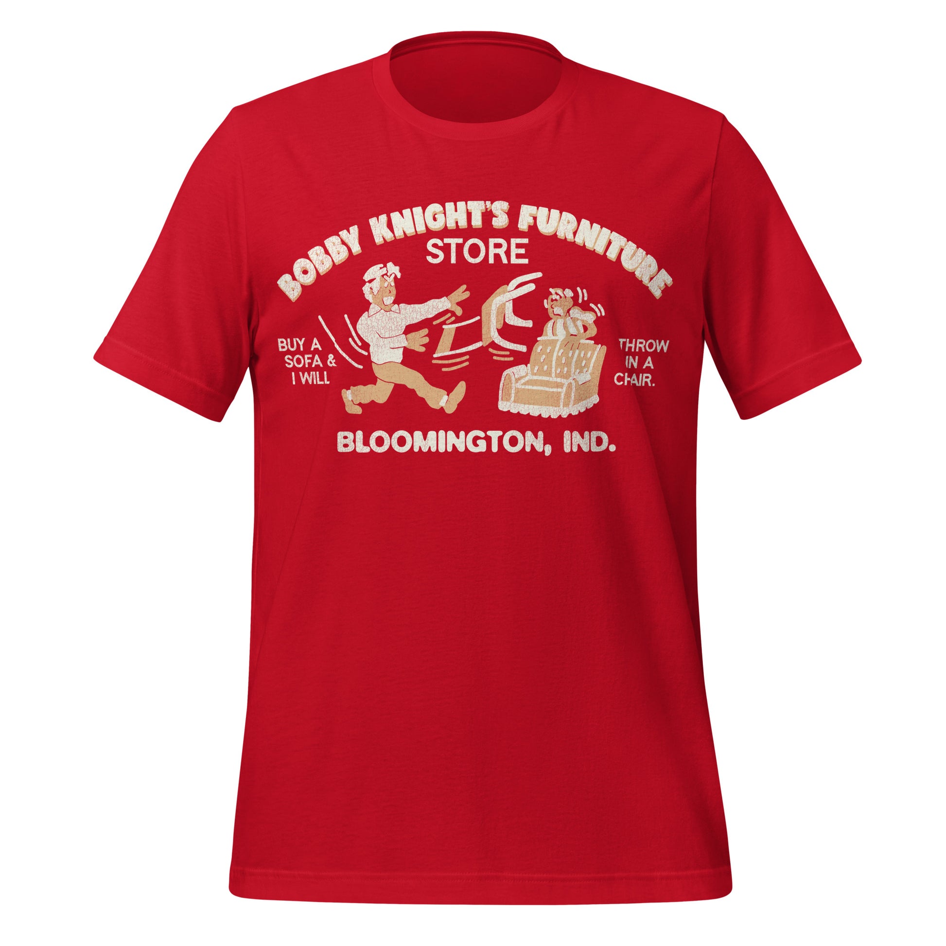 A red vintage Bobby Knight's Furniture Store t-shirt from Bloomington, Indiana. Says "Buy a sofa & I will throw in a chair" Image of terrifying man throwing a chair at a terrified man who's hiding behind a couch. 