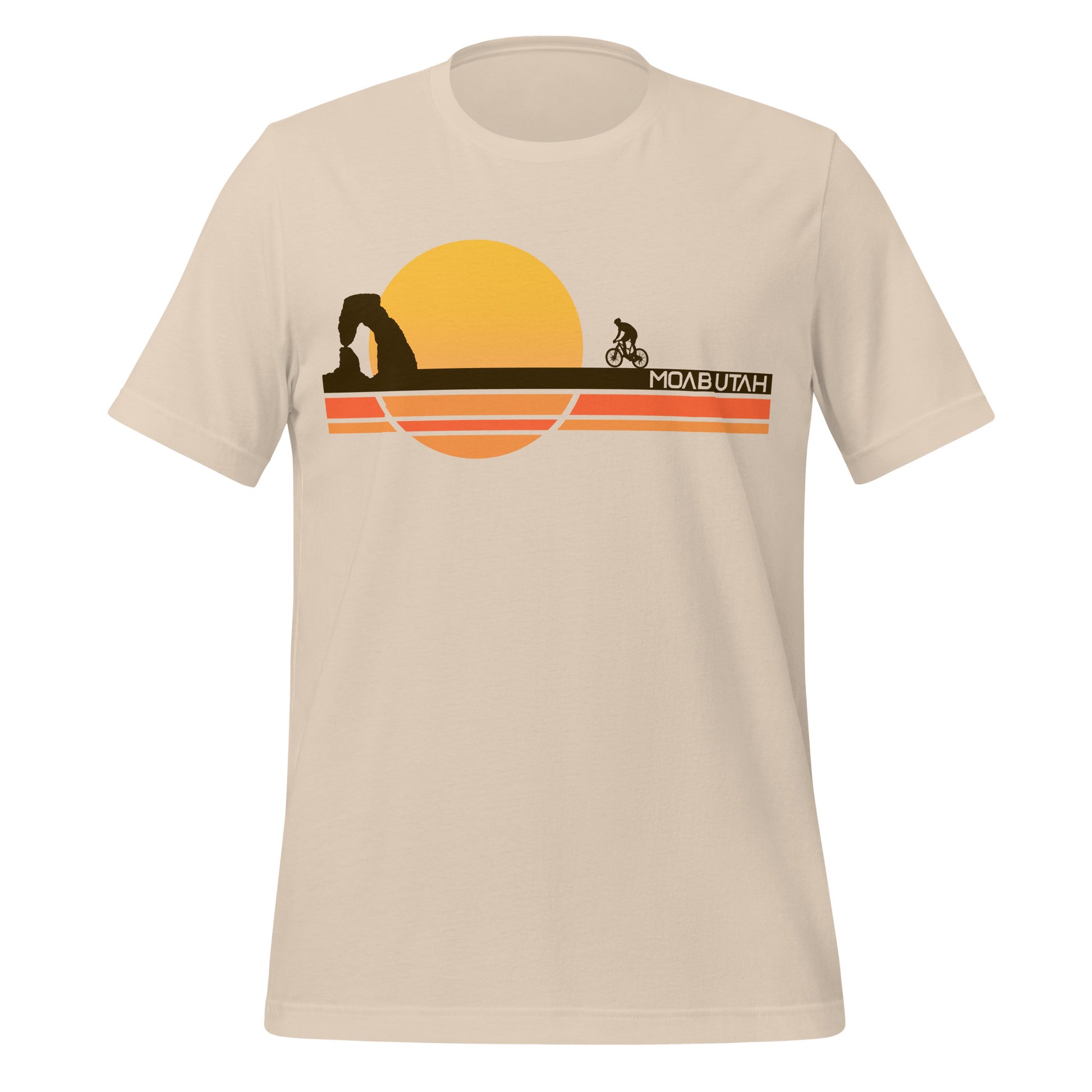 An 80s style soft cream colored Moab, Utah t-shirt for tourists with stripes of orange, yellow, and brown land over which a person rides a bike, and a sun setting. The iconic landmark Delicate Arch stands in shadow in the distance, the most famous natural stone arch in the world, a part of Arches National Park. 