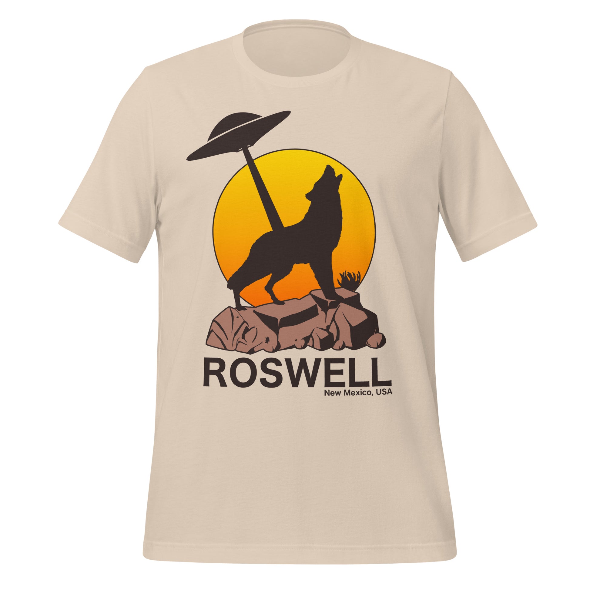 A retro 80s style t-shirt that says Roswell New Mexico, USA with the image of a wolf in shadow on top of brown rocky land, a UFO in the distance shining it's light straight down in front of a rising orange and yellow sun. In reference to the alien UFO Incident which served as a catalyst for America's UFO obsession. 