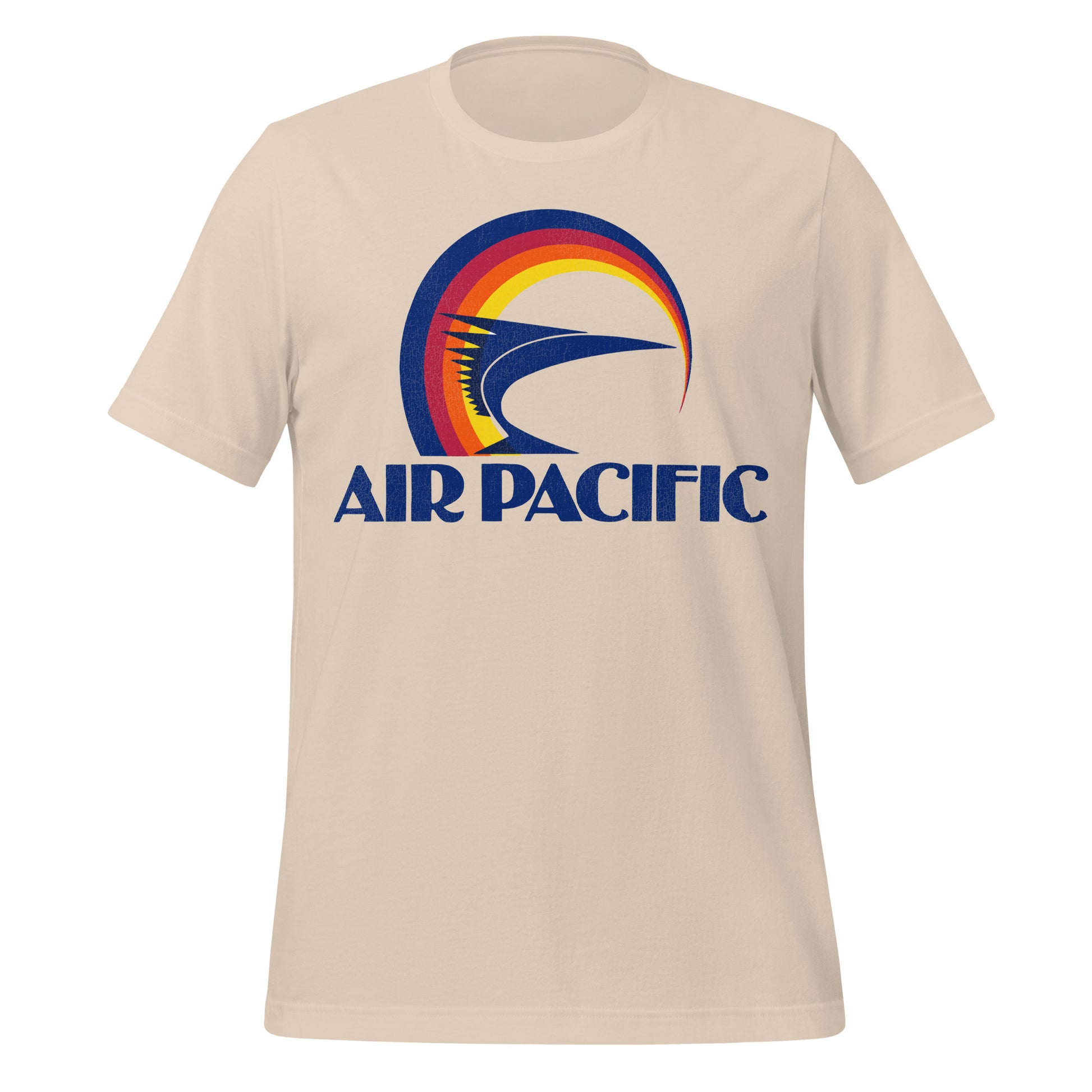 An 80s style soft cream short sleeve t-shirt that says "Air Pacific" in navy blue block letters with the colorful circle logo including a spiky fish. 
