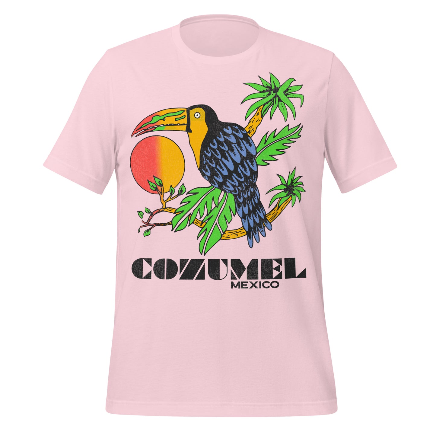 A light pink vintage travel t-shirt from Cozumel Island in Mexico, popular for cruise ship visits. Image of blue black bird with large red and orange hombre beak sitting on rainforest palm trees with a sunrise in the back. 