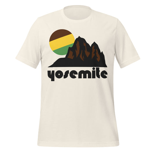 A vintage white 80s style Yosemite t-shirt with a mountain landscape image and a green, yellow, and brown sun setting behind the peaks, likely an image of the Sierra Nevada Mountain Range which houses Yosemite National Park. 