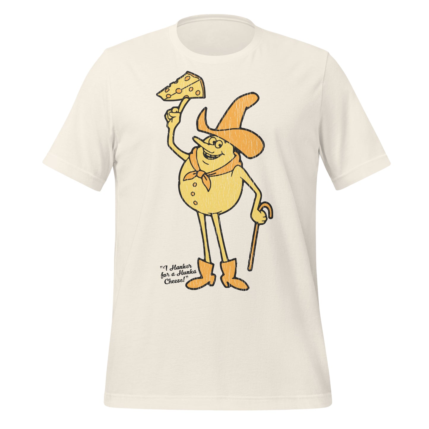 An off white vintage t-shirt that has an image of a cheese man with a hat, a scarf, a cane, and boots holding a piece of cheese with holes. Says "I Hanker for a Hunka Cheese!" 