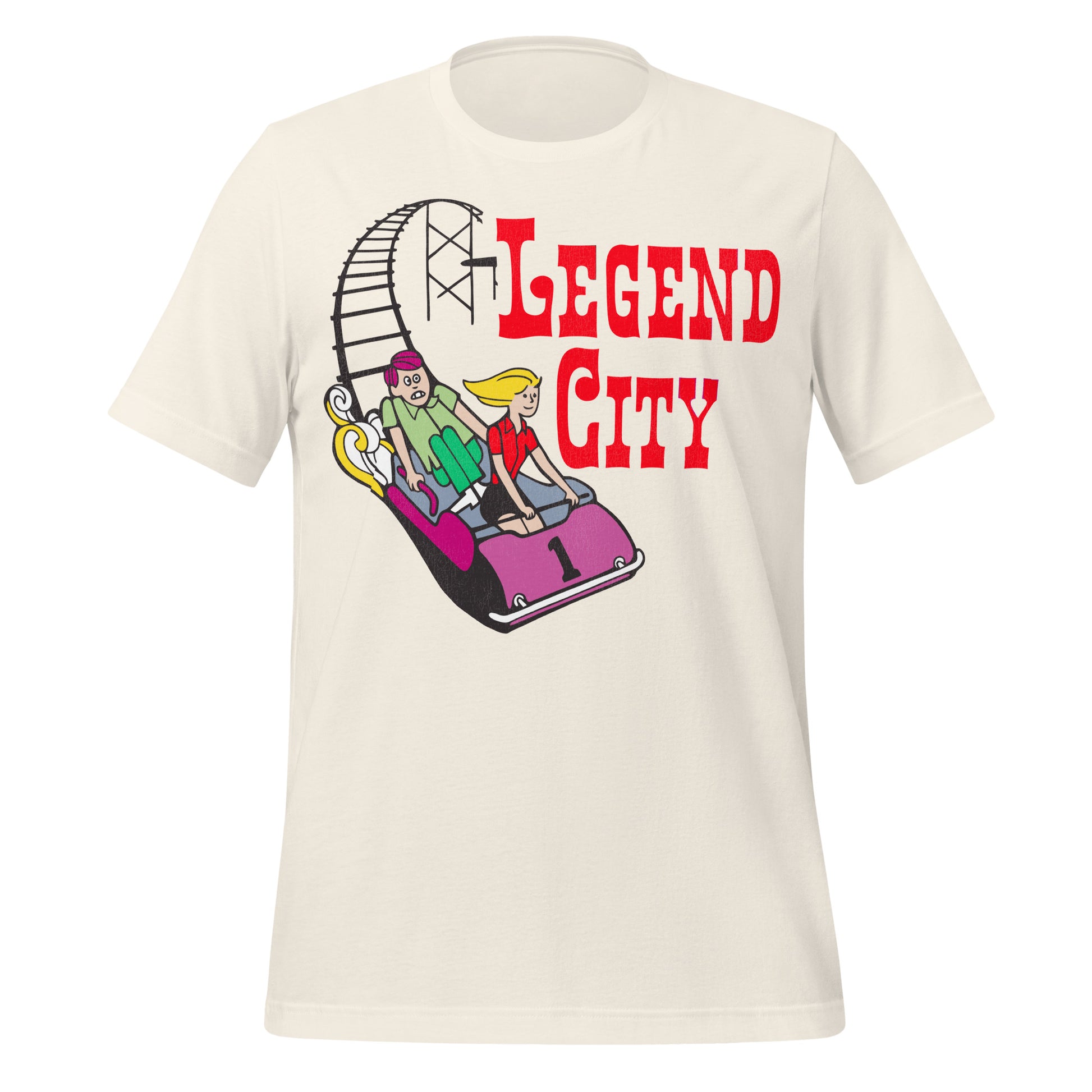 A vintage off white t-shirt that says "Legend City", referring to the legendary amusement park in Arizona that opened in the 1960s. Image of rollercoaster tracks and a couple riding in a pink #1 car, the guy scared and the girl smiling. 